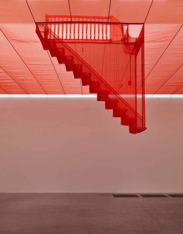 Do Ho Suh, Staircase-III: a staircase of translucent red polyester suspended from the gallery ceiling