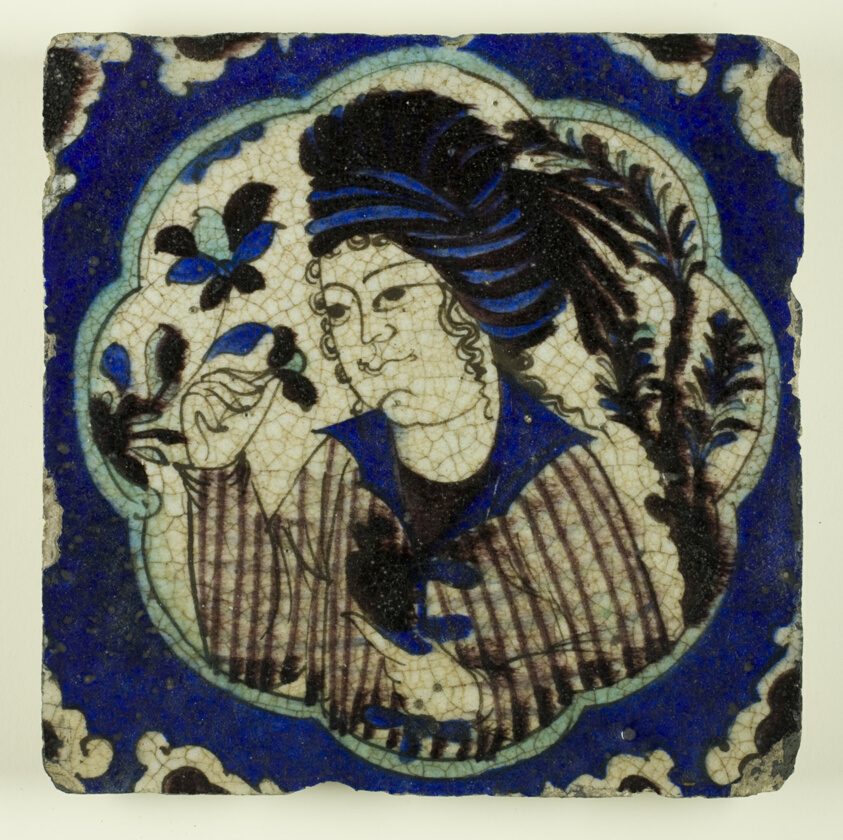 Safavid Iran, Kubachi ware. Tile with a Portrait of a Young Man Inhaling the Perfume of a Flower.