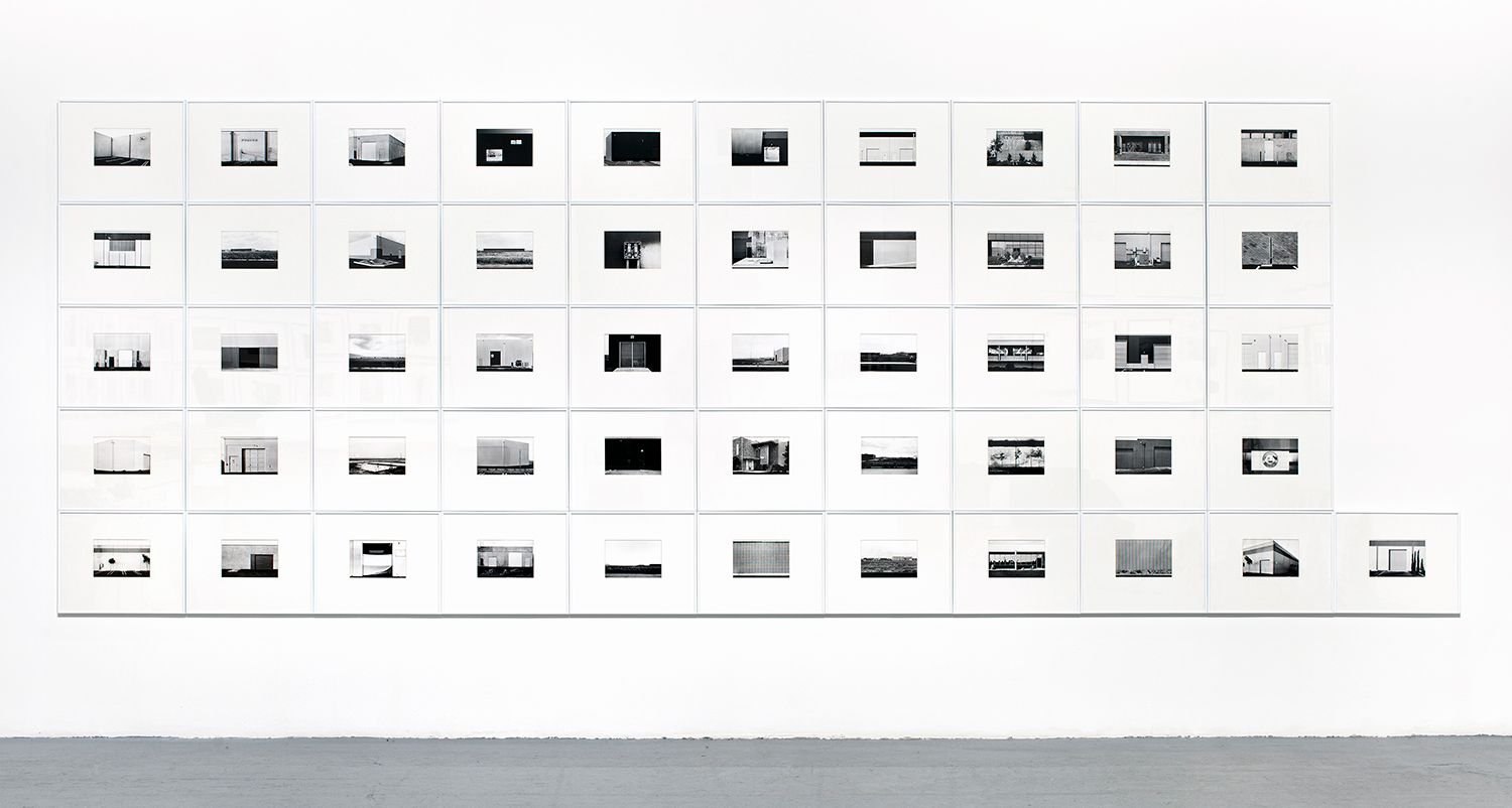 Lewis Baltz, The New Industrial Parks near Irvine, California: black and white photograph of a blank industrial facade, shot head on, no people