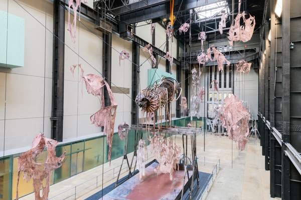 Mire Lee, Open Wound: torn pink and grey fabric hanging on long chains from the ceiling of the Turbine Hall, Tate Modern