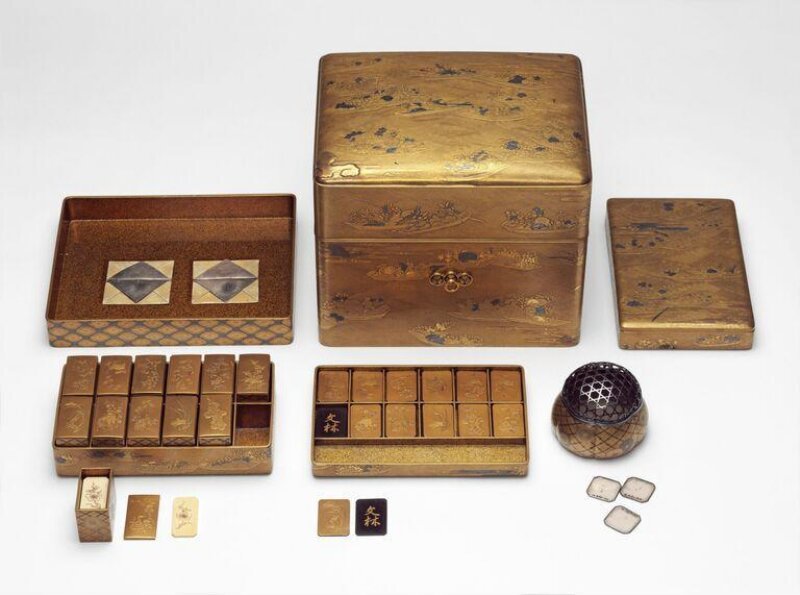Edo period incense game set in gold and silver lacquer on nashiji ground, decorated with flower laden boats among waves, with token tray and implements