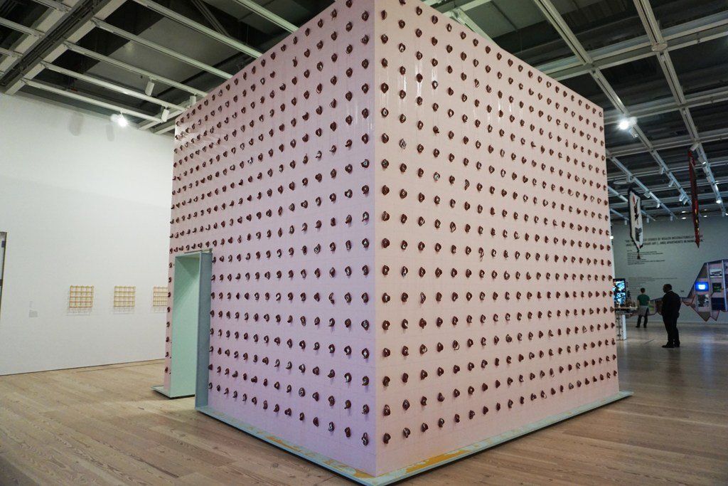 Pope.L, Claim (Whitney Version): lưới lát xúc xích bologna gắn ảnh chân dung phủ kín tường tại Whitney Biennial 2017