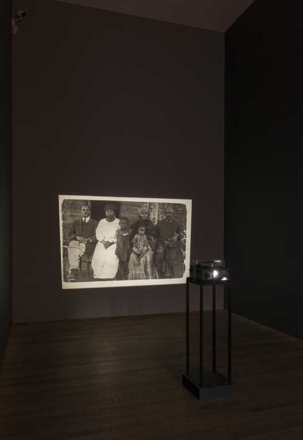 Santu Mofokeng, The Black Photo Album / Look at Me: a black and white studio portrait of a black South African sitter in formal dress